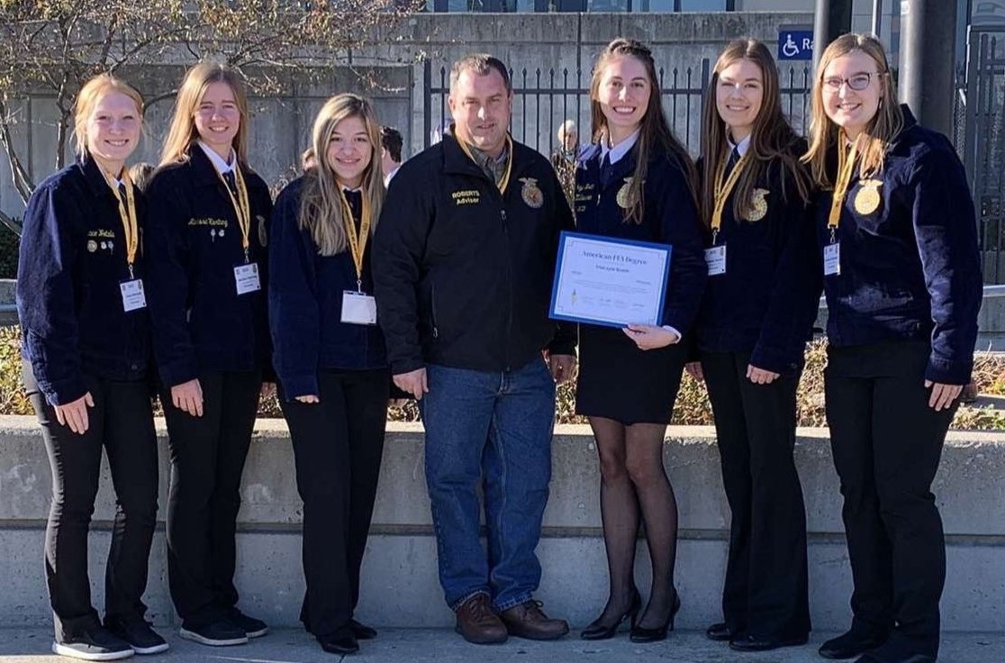 Makayla Breth, Crop Advisor at Centra Sota, pictured with her American degree and Albany FFA members