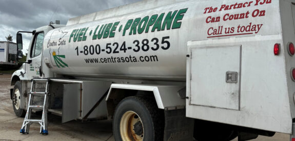 Fuel delivery truck marked FUEL • LUBE • PROPANE, with contact info visible on its side.