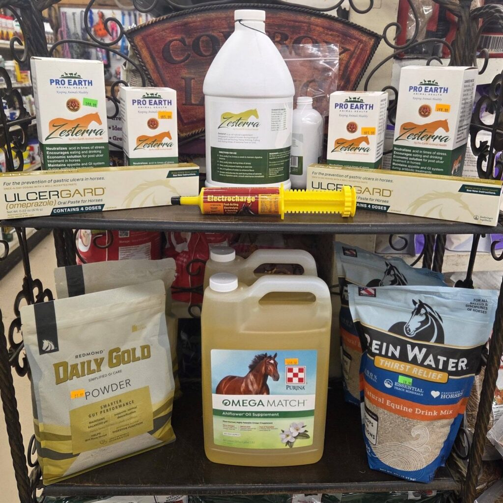 Shelf stocked with bottles and packages of horse supplements, water additives, medicines, and health products.