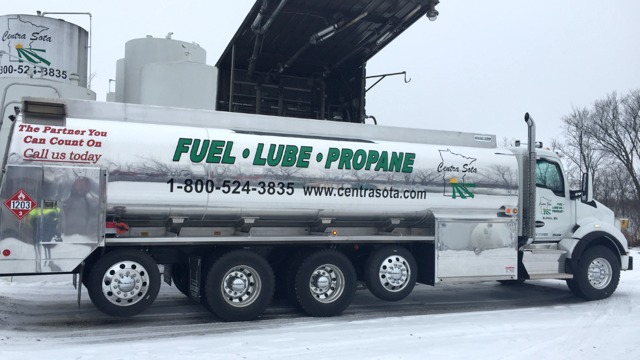 A truck marked FUEL · LUBE · PROPANE is parked in a snow-covered industrial lot.
