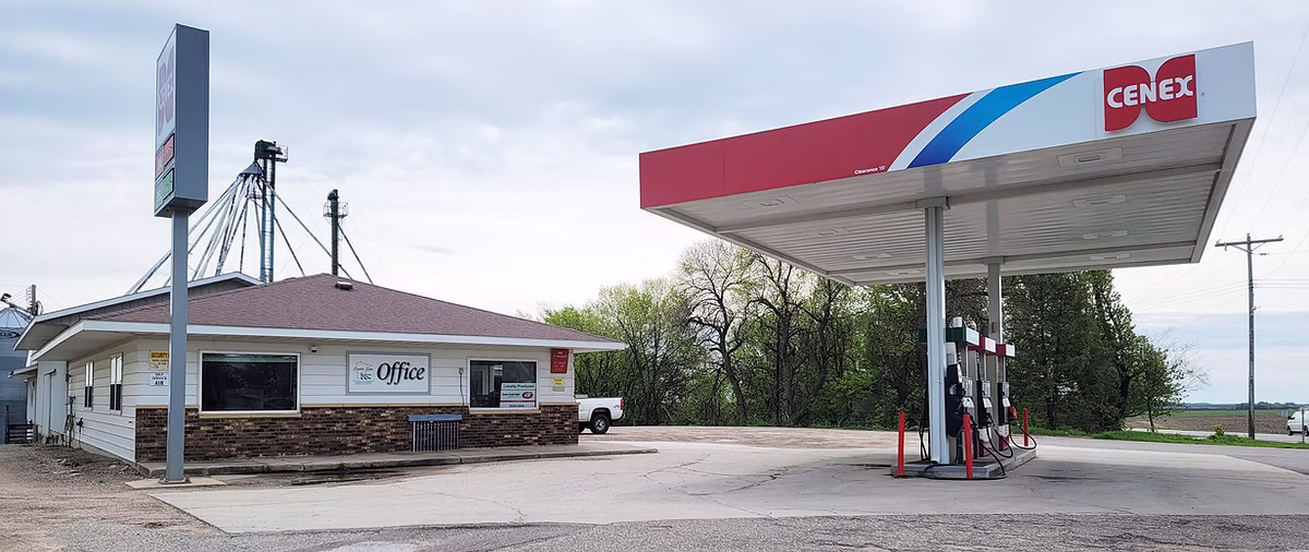 Rural gas station with Cenex canopy and Office building beneath a cloudy sky.