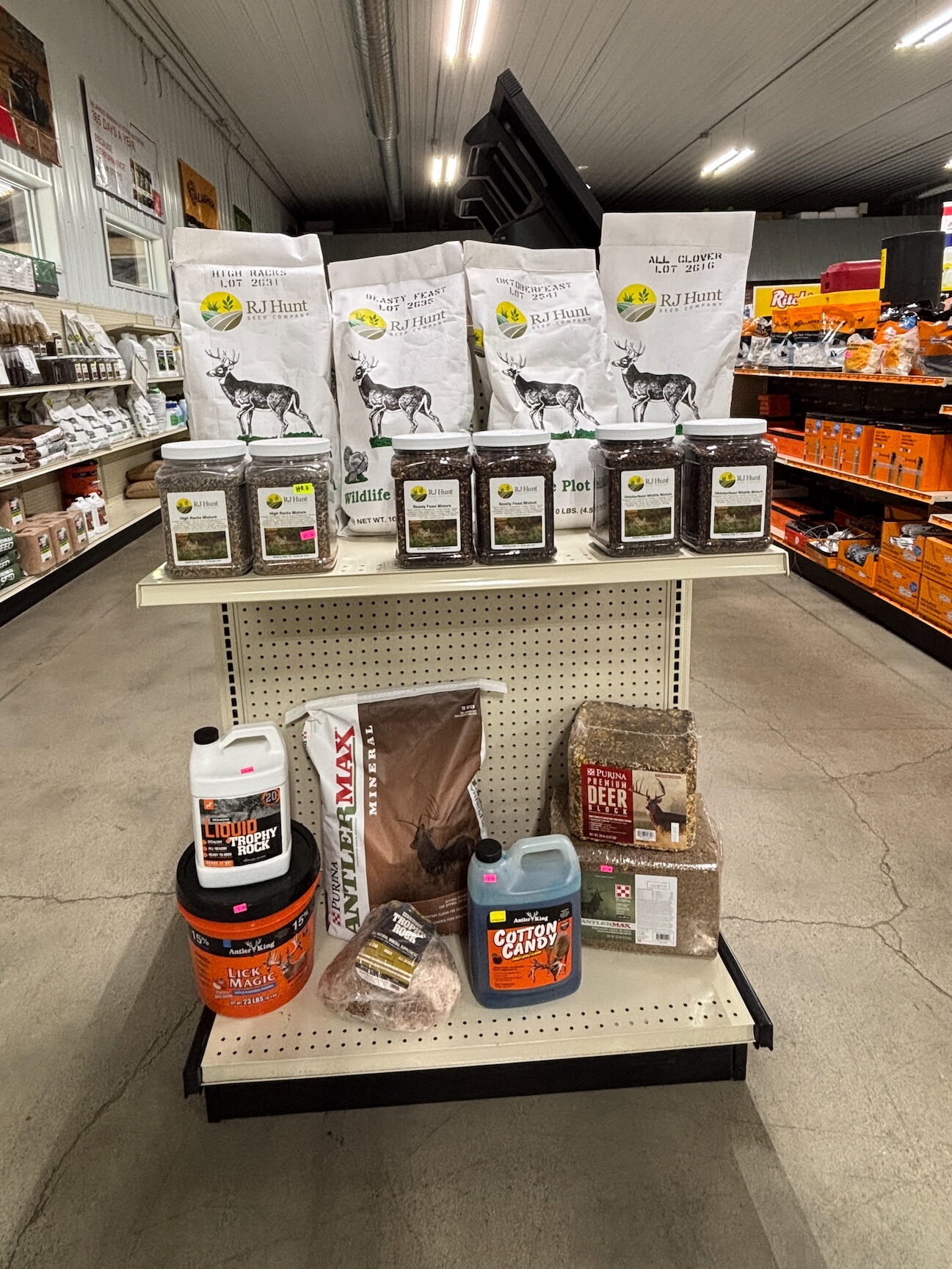 Store aisle shelves stocked with assorted bags and containers of various pet food brands.